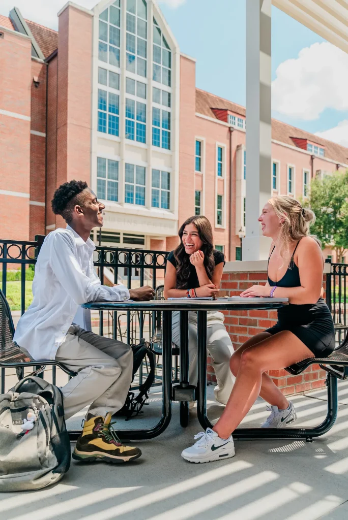 Students laughing around a table